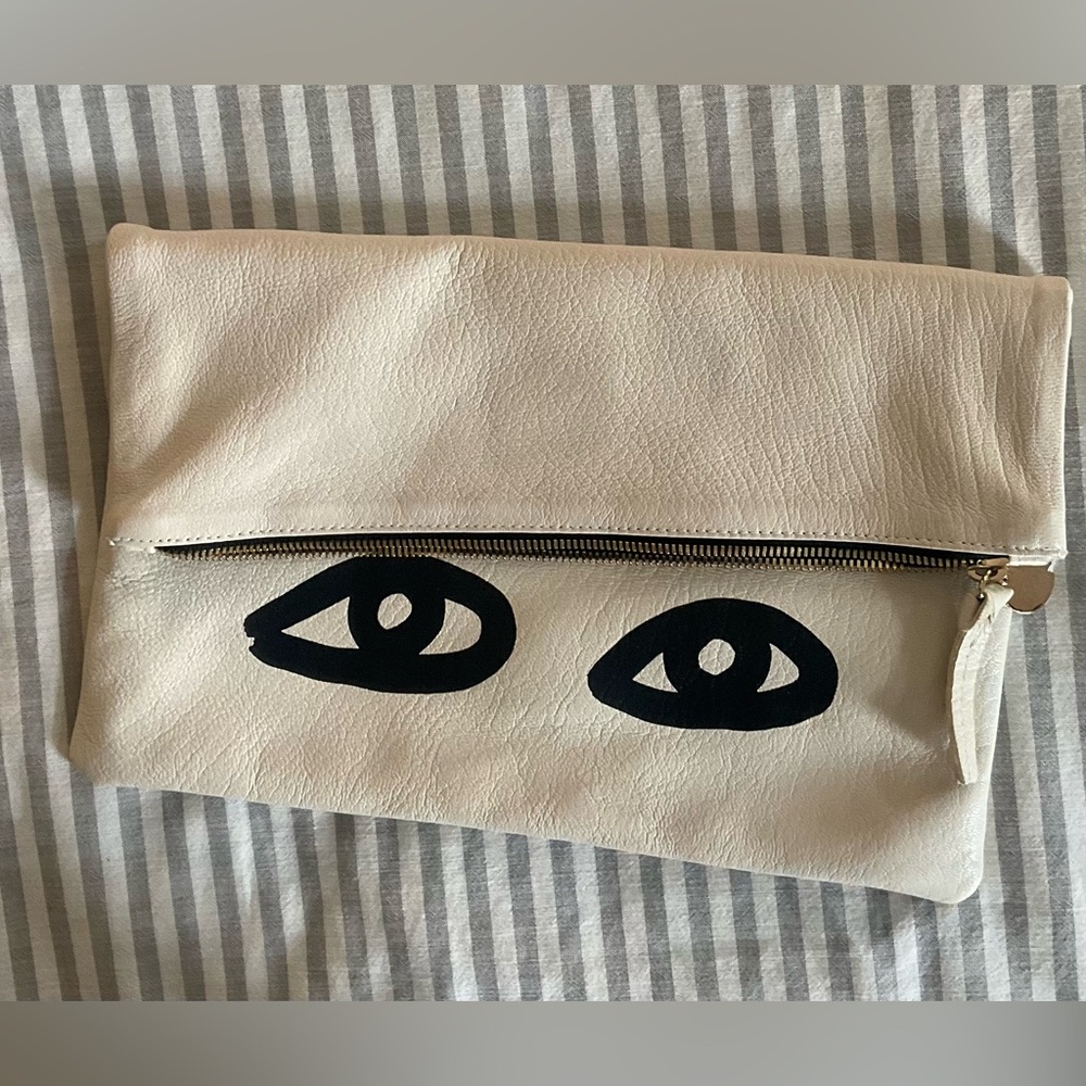 Clare V foldover leather clutch in cream with signature eyes